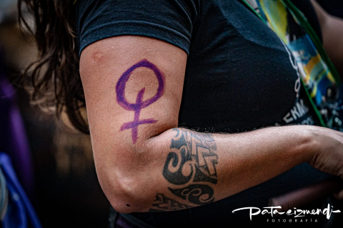 Foto de brazo de una mujer con el símbolo femenino